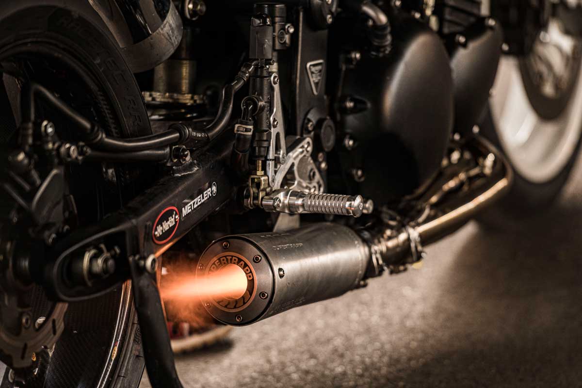 Custom motorcycle exhaust blowing a flame