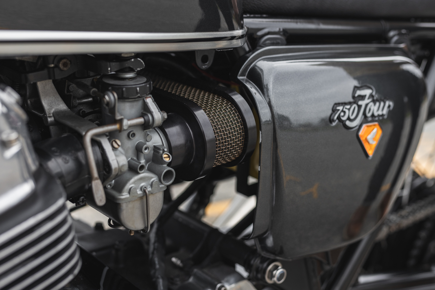 A close-up of a Honda CB750, focusing on the body and chassis of the bike.