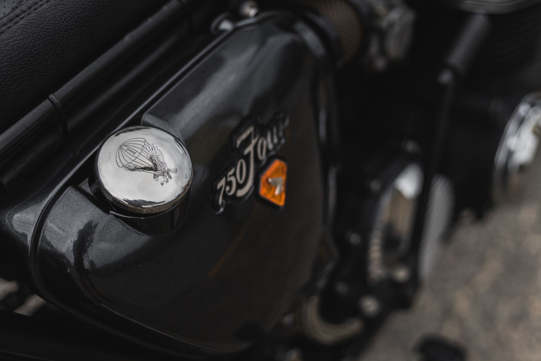 A close-up of a Honda CB750 with focus on the engraved oil tank cap