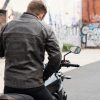Man sitting on motorcycle while wearing ol Bobber Leather Jacket by Black Pup Moto