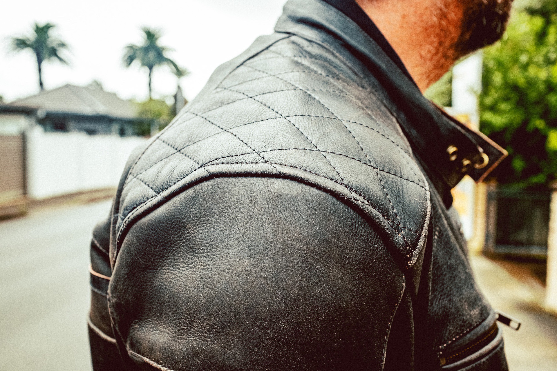 Right shoulder of man wearing ol Bobber Leather Jacket by Black Pup Moto