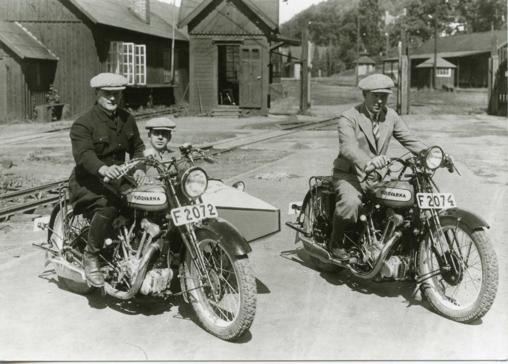 Two men riding Husqvarna scrambler motorcycles in the 1930s